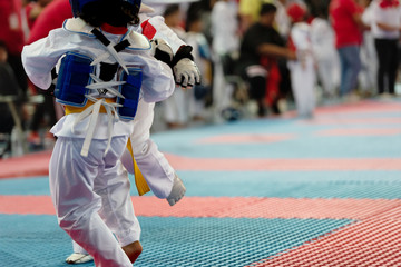 Moment of Taekwondo Kids in the stadiums. Athlete to strike an opponent during the tournament...