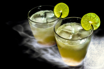Two glasses of lemon juices with ices, and smoke effect