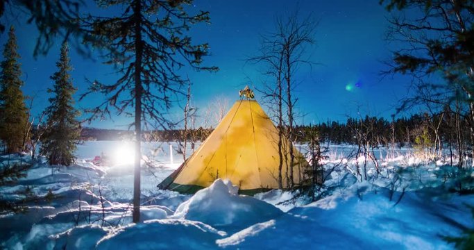 Time Lapse: People Walking in and Out of a Lit Up Teepee at Night