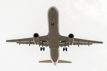 Airbus a320 landing landing in cloudy sky.