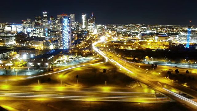 Time Lapse Aerial: Denver Skyline At Night as Traffic Headlights Blur Across Crowded Streets and Bridges