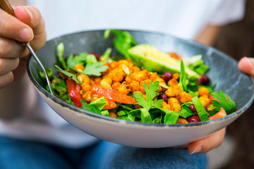 Clean eating, vegan healthy salad bowl closeup , woman holding salad bowl, plant based healthy diet...