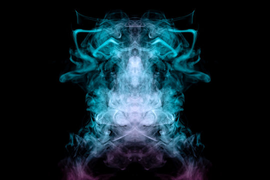 The head of a mystical animal or insect in the form of curly smoke of green and pink color with large eyes on a black background. Print for clothes.