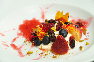 Dessert whip cream topping buy many fruit strawberry blueberry and raspberry set on white plate on cement background