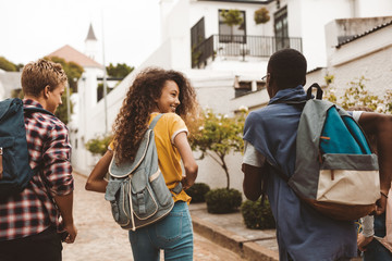 College friends walking in the street