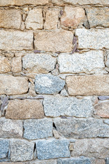 Detail of an old stone wall arranged in an irregular manner. Architecture constructions. Vintage background.