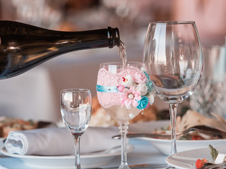 Two glasses of champagne on the background of the wedding bouquet of roses.