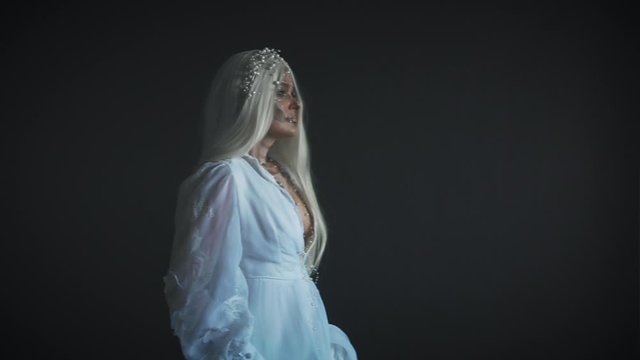 The corpse of the bride rose on the day of the celebration of the day of the dead to meet with her friends, relatives and loved ones. The ghost of a woman in a white vintage wedding dress is walking 