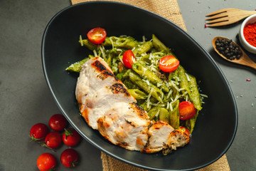 Food shot pesto pasta with grilled chicken breast