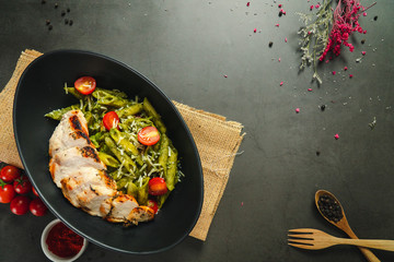 Food shot pesto pasta with grilled chicken breast