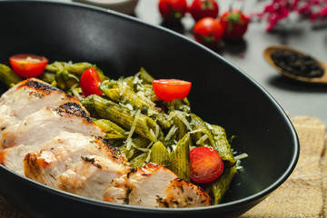 Food shot pesto pasta with grilled chicken breast