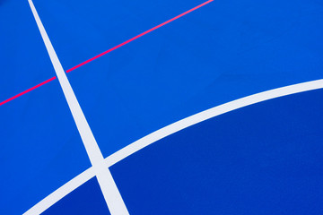 Design of a sports field, with blue background and red and yellow white lines creating strange straight lines and curves, to use with copy space.