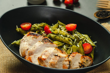Food shot pesto pasta with grilled chicken breast