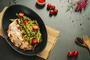 Food shot pesto pasta with grilled chicken breast