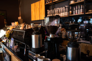 Fototapeta na wymiar Coffee grinder and espresso coffee maker on counter in coffee shop