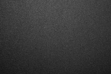 Texture of black matte plastic.Black and white matte background.The background is black rough...