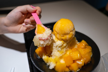 Mango fruit shaved ice and mango ice cream milk flavor serving with syrup