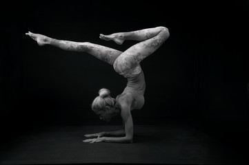 Graceful mature woman practicing yoga.  Classical black and white photography.  Scorpion pose. 
