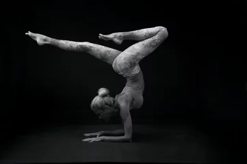  Graceful mature woman practicing yoga.  Classical black and white photography.  Scorpion pose.  © Elena Ray