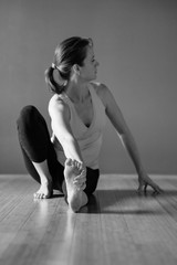 Black and white photography  Yoga woman in a sitting twisted asana 