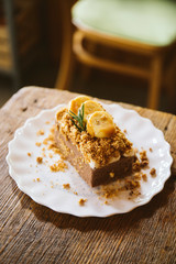 Banana caramel and hazelnut cake on wood table