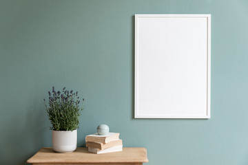 Stylish and minimalistic composition of sitting room with white mock up frame, wooden shelf,...