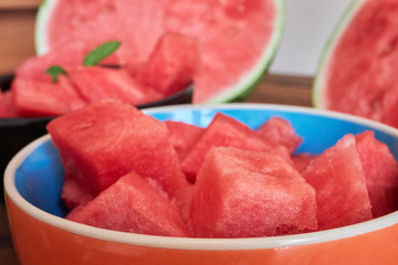 Two bowl with fresh watermelon on dark table