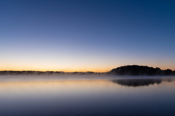 Fototapeta na wymiar Sunrise Fog on the Lake