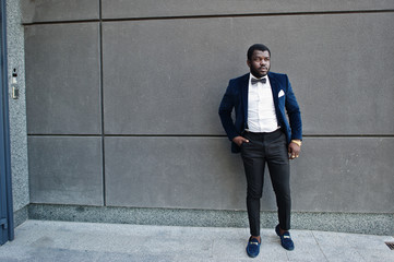 Handsome fashionable african american man in formal wear and bow tie.