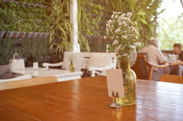 flowers in a vase on the table in restaurant 