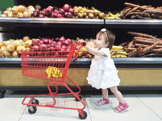 Baby girl with shopping cart © PixieMe