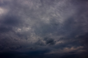 Dark rain clouds during sunset. Dramatic sky during sunset. Dark storm clouds with black and white...