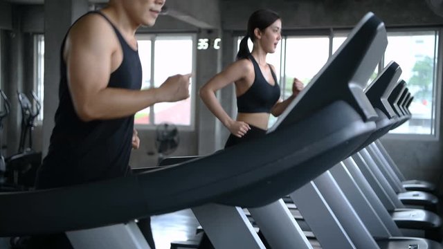 Sports concept. Men and women are running together at the fitness center.