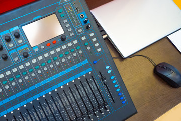Equipment for conferences. The mixing console is connected to the computer. Sound equipment for seminars. The mixer is connected to a laptop. Organization of press conferences. Music processing