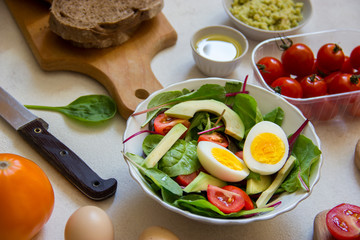 Vegetarian salad with eggs, avocado, and tomato.