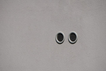 round white holes for ventilation in the wall, forced ventilation in the wall of an old apartment...