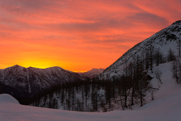 Snowy panorama of the Val Bognanco that opens behind Domodossola at the dawn, Piedmont