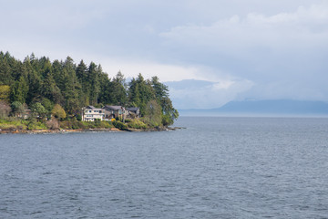 houses at cliff , rainy and foggy mountain and forest view over coast and bay near Vancouver island at Nanaimo, Canada 