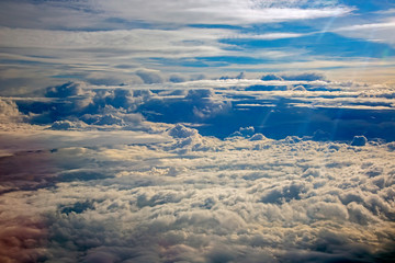 Naklejka premium fluffy clouds from the plane window in flight.