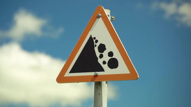 Road sign, rockfall. Falling stones register up and down.