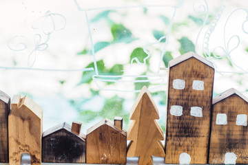 Designer hand present wooden shape house model home insurance ideas concept