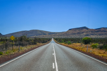Hot tarmac and pink deep purple gravel at Karijini National Park