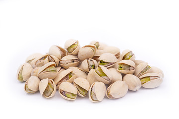 A bunch of tasty and nutritious pistachios on a white background close-up. Nutritious and healthy snack   