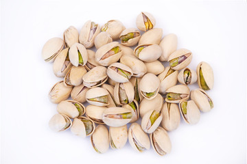 A bunch of tasty and nutritious pistachios on a white background close-up. Nutritious and healthy snack       