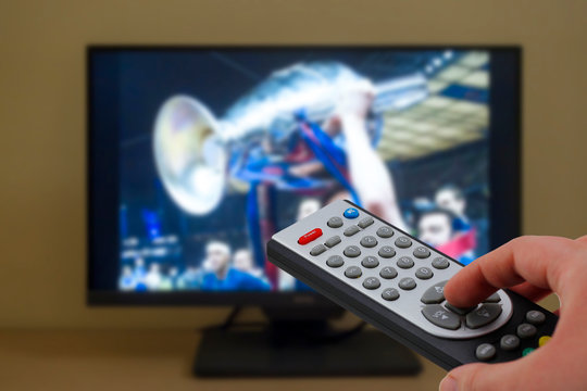 Sports television remote control in the hand, zapping