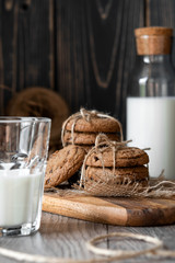 Chocolate chip cookies and milk on wooden background
