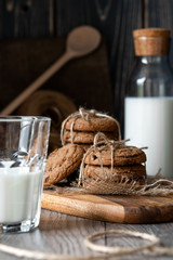 Chocolate chip cookies and milk on wooden background