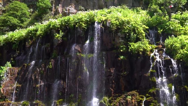 waterfall in a tropical forest on a sunny hot day. Georgia, waterfall Dashbashi. slow motion