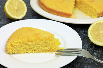 Homemade Slice Of Lemon Drizzle Cake On A Plate.
