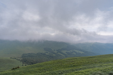 Fototapeta na wymiar Mountain range in clouds in Bieszczady, Poland.